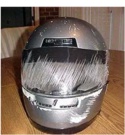 Fig: 2.5: Accident damaged helmet shows how the chain bar and face shield protected the user  (Source: Wikipedia) 