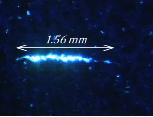 Figure 1.1: Fluorescent Dye penetrant crack indication in Nickel alloy bar [Rolls-Royce plc