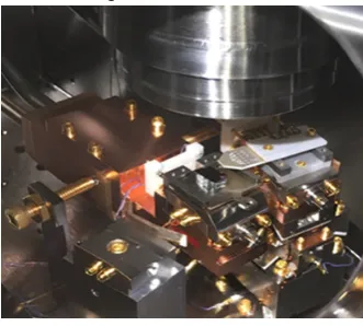 FIG. 5: First generation of four-point probe, poised above a sample in the probe station