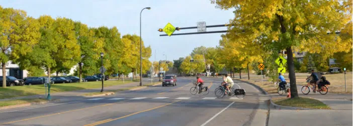 Figure 1.1 - Bicyclists crossing Minnehaha Avenue at the Midtown Greenway.