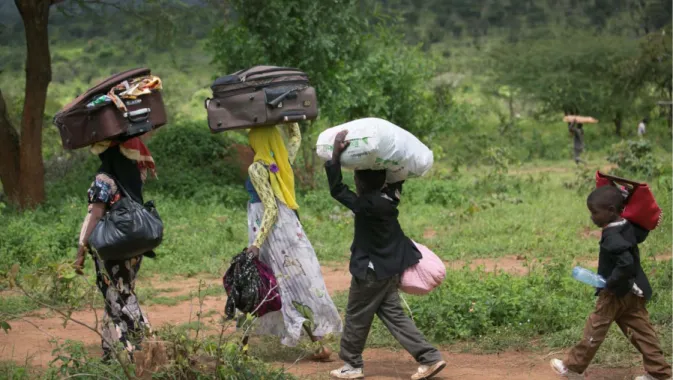Figure 5: Moussa runs after the rest of his family as they head towards their tent in Mahama Refugee Camp,  Rwanda