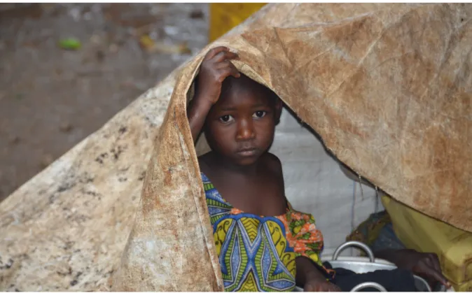 Figure 9: A Burundian refugee child takes shelter in Kagunga, Tanzania. UNHCR/ T.W.Monboe 