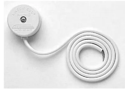 Figure 21-8    A vibration  glass-break detector  is mounted on a  windowpane to  sense vibrations  from knocks,  taps, or hits on  a window