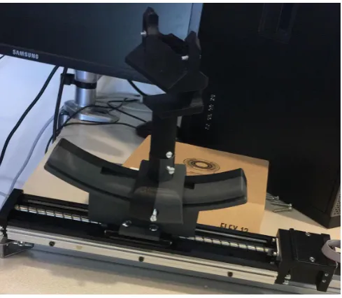 Fig. 6.The linear stage with the ultrasound holder attached to it.Adjustments of the probe’s orientation and location are possible via thescrews in the holder.