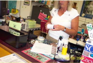 Figure 3:  Poll Worker attempting to fix a jammed VVPAT printer.  [11] 
