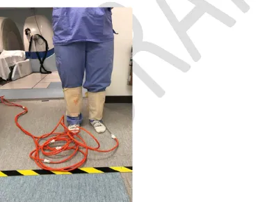 Fig. 2. A patient in the standing position of open magnetic resonance imaging (MRO) examination with a compression cuff around each leg