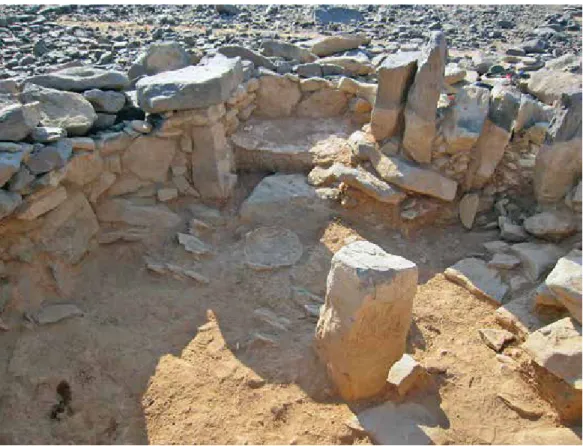 Figure 3. Central pillar, alcove, and plastered basin in structure W-66 (photo by G. rollefson)